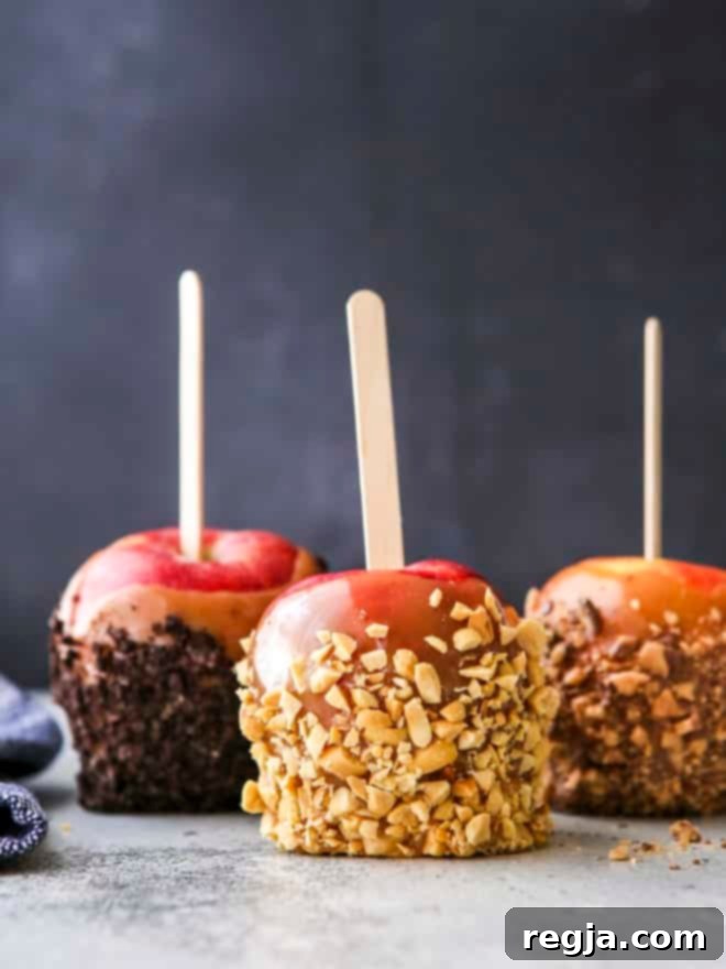 caramel apples with crushed oreos, nuts, and crushed candy bars