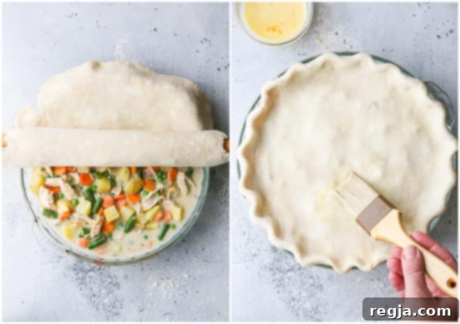rolling pie crust over pot pie filling, and brushing with egg wash