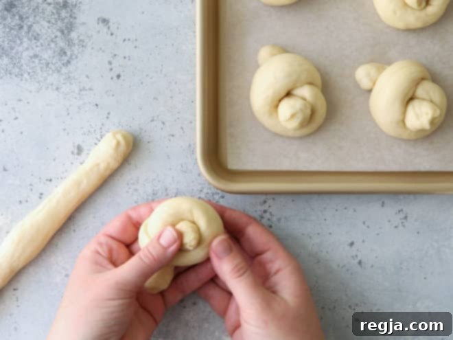 shaping white dinner roll knots