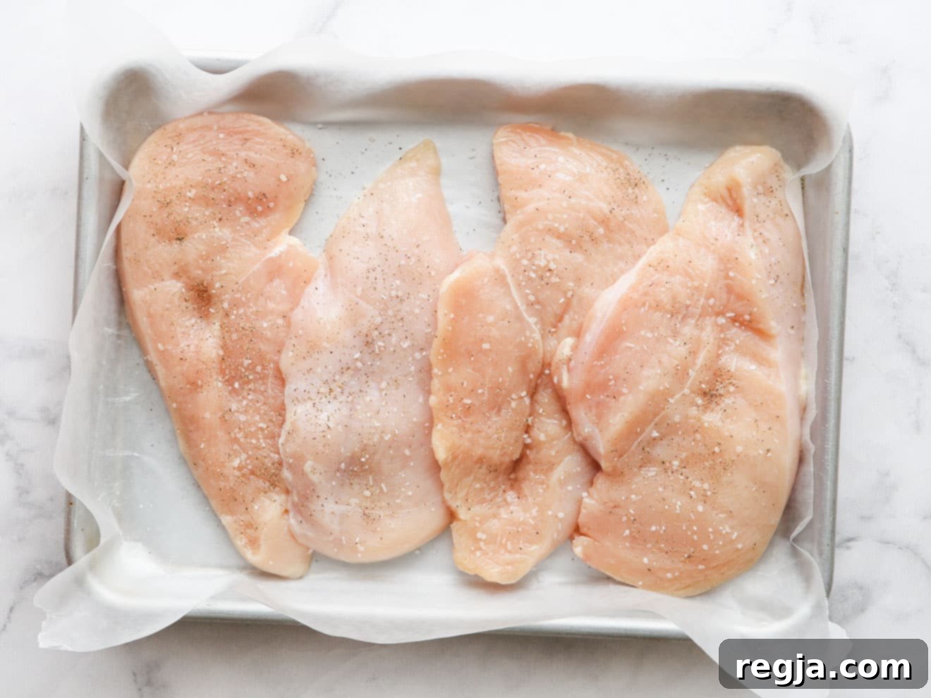 sliced chicken breasts with salt and pepper
