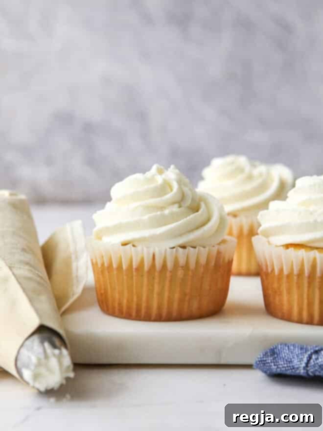 piping chantilly cream frosting onto cupcakes