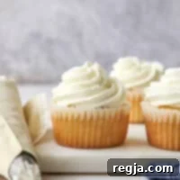piping chantilly cream frosting onto cupcakes