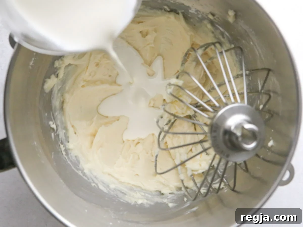 adding heavy cream to mixing bowl