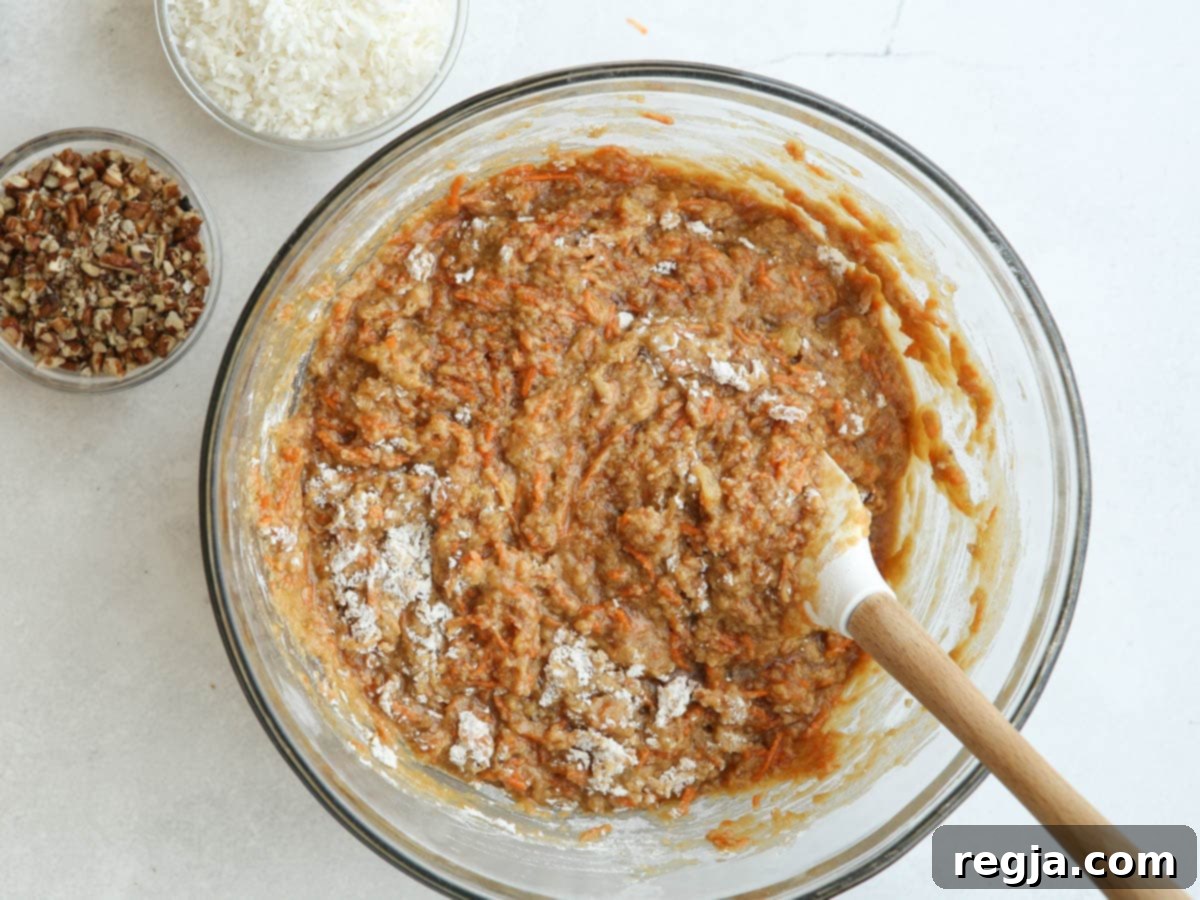 mixing carrot cake batter in a bowl